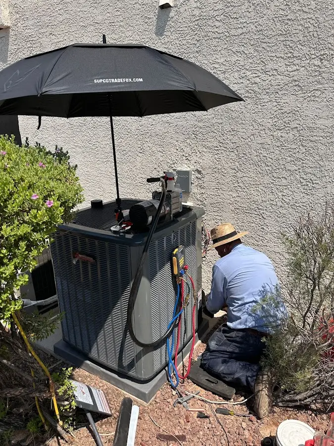 HVAC technician performing outdoor AC maintenance in Sawmills